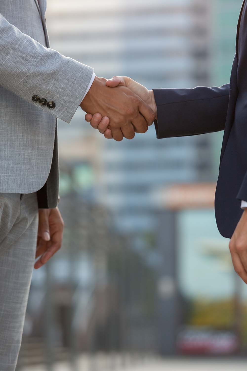 businesspeople-standing-city-street-shaking-hands s